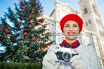 Woman with camera standing near Duomo in Christmas Florence