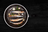 Grilled anchovy fish on pan.