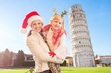 Mother with daughter spending Christmas time in Pisa, Italy