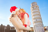 Happy mother with daughter spending Christmas in Pisa, Italy
