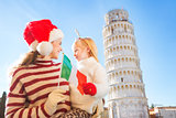 Mother and daughter holding Italian flag. Christmas in Pisa