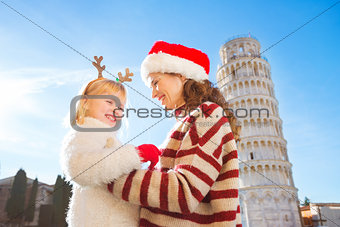 Happy mother in Christmas hat and daughter. Christmas in Pisa