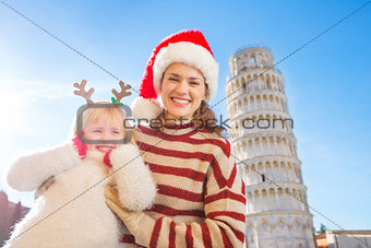 Happy mother and daughter spending Christmas time in Pisa, Italy