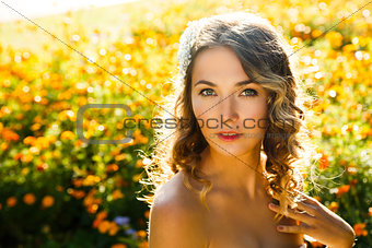 Beautiful Woman on Summer Flowers Background
