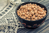 Raw chickpeas in wooden bowl