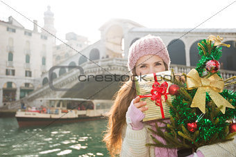 Young woman with Christmas tree and gift box in Venice, Italy