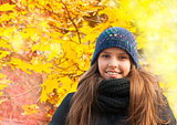 Portrait of smiling young girl in autumn
