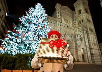 Closeup on gift box in hands of woman in Christmas Florence