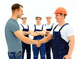 Customer Shaking Hands With Builder