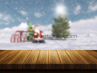 Wooden table with defocussed Christmas santa landscape in the ba