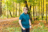 Young smiling man portrait laying in  autumn park.