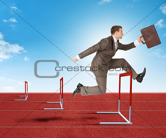 Businessman hopping over treadmill barrier