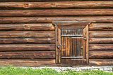 Old log house wood wall with closed door and padlock
