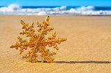 golden christmas ornament on the beach