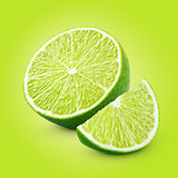 Half and slice of lime citrus fruit