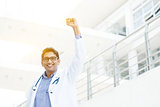 Excited Asian Indian medical doctor celebrating success