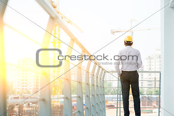 Back side of Asian Indian male site contractor engineer