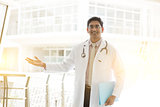 Asian Indian medical doctor welcome hand sign