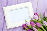 Purple tulip bouquet and blank photo frame