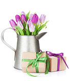 Purple tulip bouquet in watering can and gifts