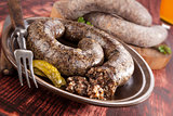 Blood sausage and rice sausage on wooden background. 