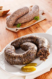 Blood sausage and rice sausage on wooden background.