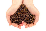 Heart symbol of bean coffee in feminine hand