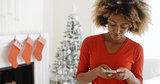 Young woman checking her Christmas messages