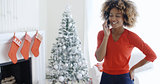 Happy young woman chatting on her mobile at Xmas