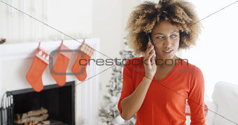 Trendy young woman chatting on her mobile at Xmas