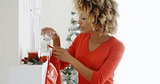 Happy young woman hanging Christmas stockings