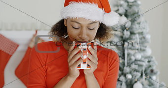 Young woman enjoying hot coffee at Christmas