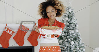 Happy trendy young woman with a Christmas dessert