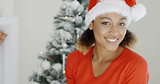 Happy festive young woman in a Santa hat