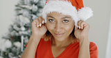 Attractive young woman donning a Santa hat