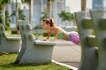 Woman Training Pectorals Doing Pushups On Street Bench