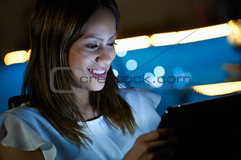 Young Student Using Tablet PC Indoor At Night