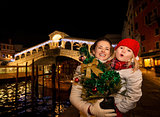 Happy mother and daughter with Christmas tree in Venice, Italy.