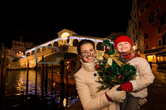 Mother and daughter with Christmas tree near Rialto Bridge