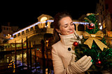 Woman with Christmas tree near Rialto Bridge in Venice, Italy
