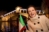 Happy elegant woman spending Christmas time in Venice, Italy