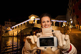 Woman taking selfie while spending Christmas time in Venice