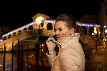 Woman talking cellphone while spending Christmas time in Venice