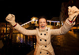 young woman rejoicing spending Christmas time in Venice, Italy