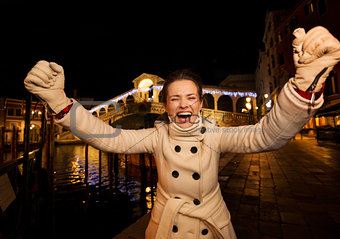 young woman rejoicing spending Christmas time in Venice, Italy