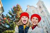 Portrait of mother and daughter near Christmas tree in Florence
