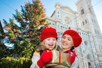 Mother and daughter excited about Christmas gift in Florence