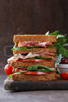 sandwich of rye bread with ham and vegetables