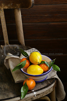 citrus fruit tangerines and lemons on the old vintage chair