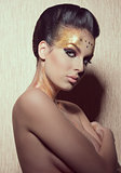 woman with golden artistic make-up 